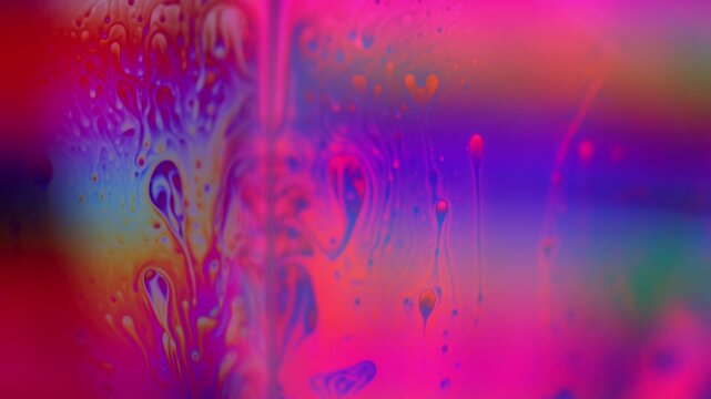 Pink liquid, bubble in macro, movement of liquid in a bubble, green absorption, chaotic movement, silver fluid structure