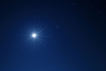 Obraz premium The bright star illuminating the night sky, with a serene celestial background, shining among numerous twinkling stars, on a clear dark night, astronomy concept.