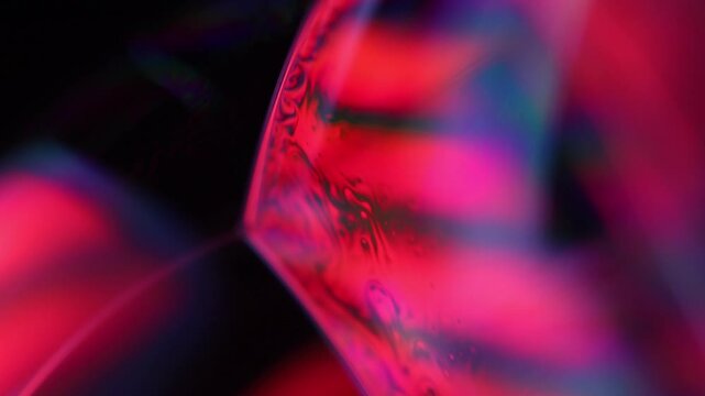 Red  liquid, bubble in macro, movement of liquid in a bubble, chaotic movement, fluid structure, dark rainbow 