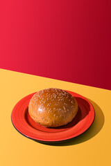 Still life of a hamburger bun on a plate. Copy space.