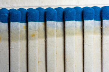 Set of wooden matches with the head or blue flammable material.