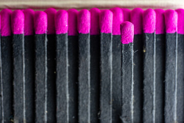 Set of black cardboard matches with the head or red flammable material. Lined up with an off-site.