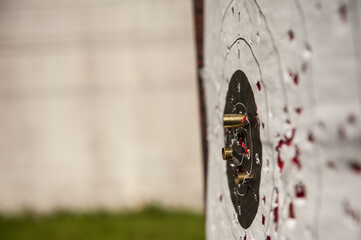 Old practice shooting target, damaged gun, bullet traces