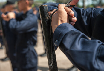 Riot police practice using batons in the field