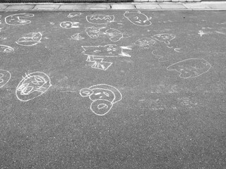 路地のアスファルトに描かれた子供の落書き