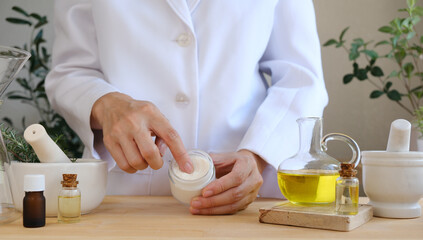 The scientist, dermatologist testing the organic natural skincare product in the laboratory. Beauty cosmetic research and development concept.