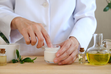 The scientist, dermatologist testing the organic natural skincare product in the laboratory. Beauty cosmetic research and development concept.