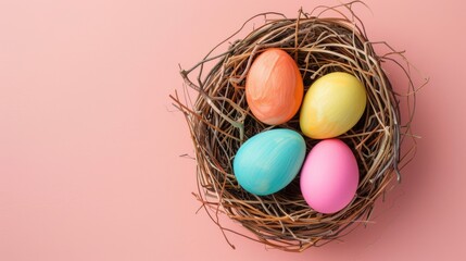 Obraz premium Vintage Easter eggs in bright colors in a nest on pastel pink backdrop