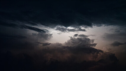 Dark clouds lightened by lightening at summer night.