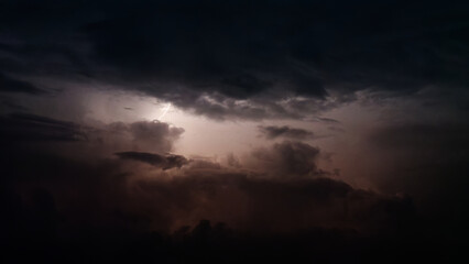 Dark clouds lightened by lightening at summer night.