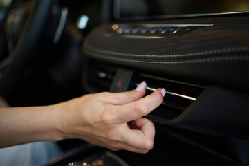 Expert is operating the control panel of a luxury vehicle with advanced technology and sleek design