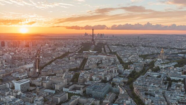 Aerial view of Paris taken at the sunset with the Eiffel tower and La Defence district skyscraper in the background, Paris, France - Timelapse transition