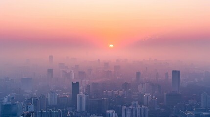 Fototapeta premium Smoky haze over a cityscape at sunset