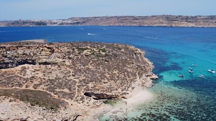 Fototapeta premium Beautiful white sand beach on Uninhabited Cominotto island, Comino, Malta. Aerial shot. High quality photo