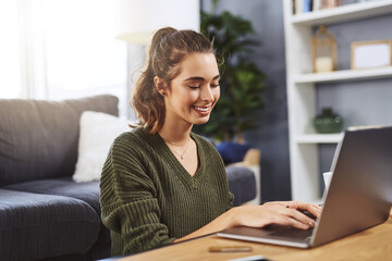 Typing, floor and girl with laptop at table for studying, assignment or literature essay in living room. Online, college student and woman with computer for education, knowledge or learning in home