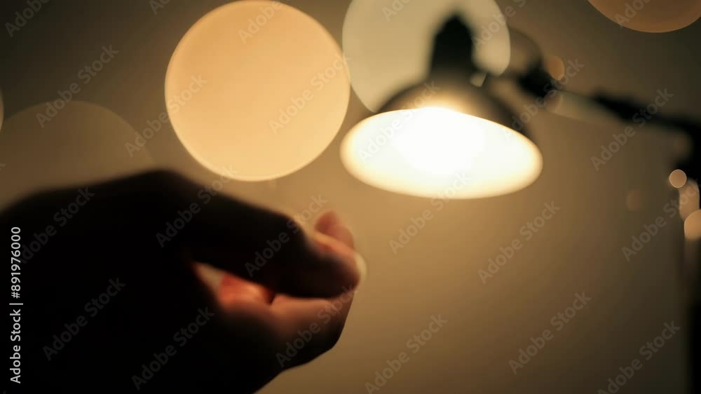 Poster a hand frantically reaching for a nearby lamp trembling as it fumbles to turn on the light and dispe