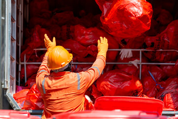 Asian man worker wear protective Infectious waste, Red garbage waste disposal infectious waste garbage red garbage bag, Logistics control infectious waste hospital.