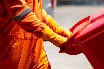 Asian man worker wear protective Infectious waste, Red garbage waste disposal infectious waste...