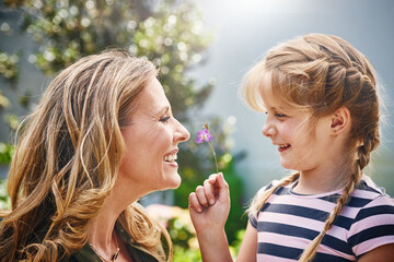 Flower, love and mom and child in garden for conversation, laughing and having fun bonding...