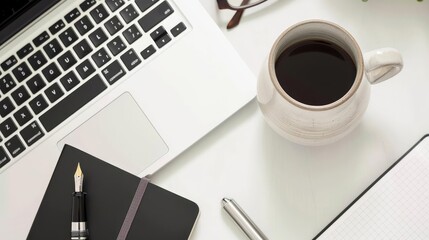 Top-down image of a modern desk with a ceramic coffee mug