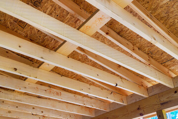 Building new home involves framing roofing trusses with wooden frame beams