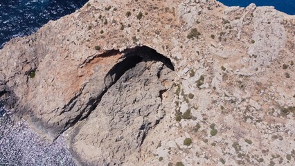 Natural windows in the rocks, Comino Island Malta, Close up revealing drone shot. High quality photo