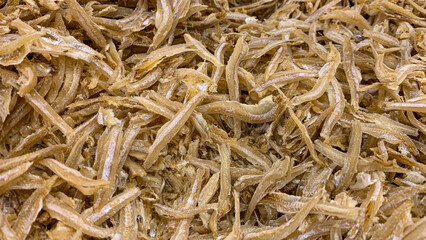 Close up top view of anchovies displayed in supermarket. Dry seafood concept.