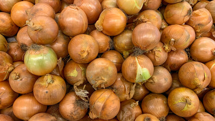 Top view of white onions displayed in supermarket. Healthy food concept