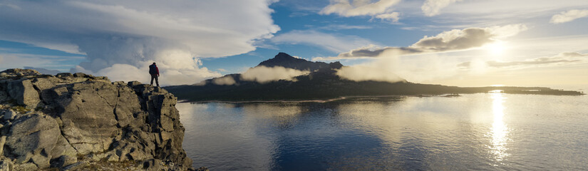 Adventure Man standing on cliff looking on island by ocean. 3d rendering