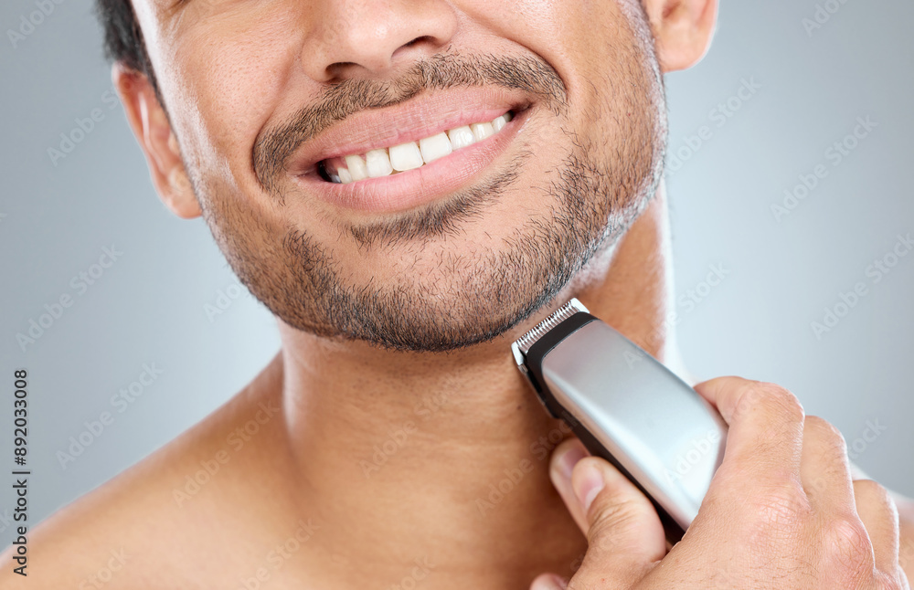 Poster Electric, razor and hand of man in studio by beard for grooming, facial epilation and wellness or skincare. Person, cosmetic tool and shaving for hair removal, gray background and closeup routine.