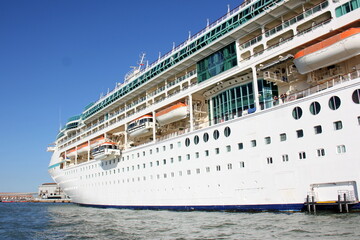 A large cruise ship stands at the pier.
