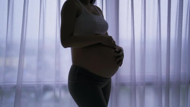 Depressed lonely Asian pregnant divorce woman in bedroom at home. Having a baby. Family people lifestyle. Mom.