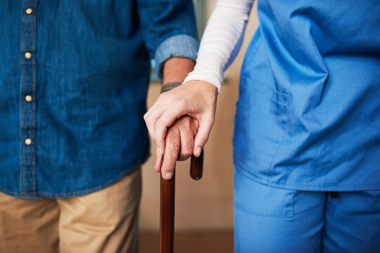 Hands, caregiver and senior man with cane for walking support, help and balance of rehabilitation recovery. People, patient and male person with disability, physiotherapy and mobility on retirement