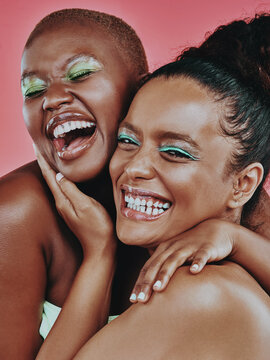 Woman, friends and bold makeup with smile, cosmetic and on pink background. Eyeshadow, embrace and hand for female model person, glam and glow for creative cosmetology and happy aesthetic together