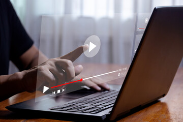 Man using laptop to stream online on virtual screen Streaming video on internet concept Watch videos on the internet, live concerts, performances or tutorials. online business content