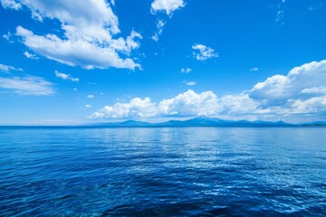 Obraz premium Tranquil Seascape: The Enchanting Beauty of a Pristine Blue Ocean Background, Exuding Serenity and Timeless Elegance.