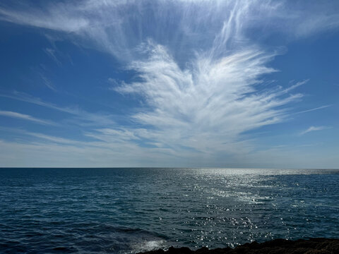 Blue sea glittering water and amazing cloud in the sky 
