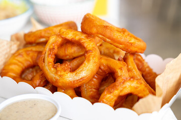 Paper box with fried  onion rings. 