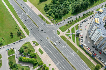 aerial view of intersection of the road with cars traffic in urban residential area.