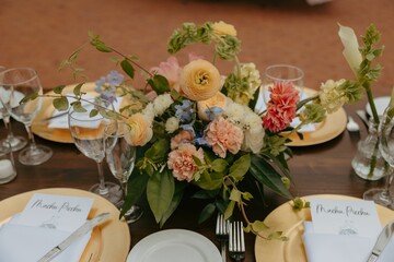Beautifully arranged wedding table setup with floral centerpiece and elegant tableware