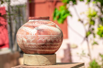 Traditional Earthen Pot in Sunny Outdoor Setting