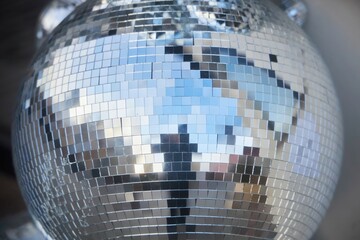 A large mirror with a silver ball decoration on it.
