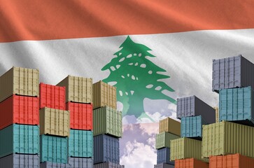 Lebanon flag and big stack of shipping cargo containers in docks with sky background close up
