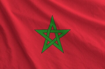 Morocco flag depicted on folded wavy fabric of old cloth close up