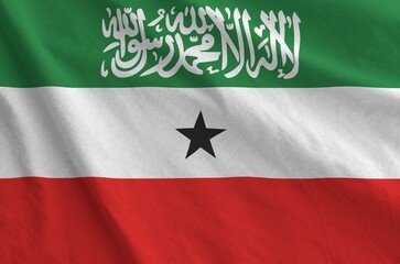 Somaliland flag depicted on folded wavy fabric of old cloth close up