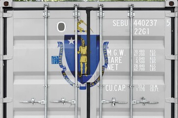 Massachusetts US state flag depicted on metal doors of shipping cargo container outdoors in docks...