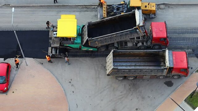 Road surface repair works. The paver is laying new asphalt.