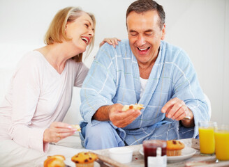 Mature couple, bedroom and food for care, breakfast and nutrition for retirement health. Senior woman, man and croissant or muffin with fruit jam for diet, romance and elderly wellness or support
