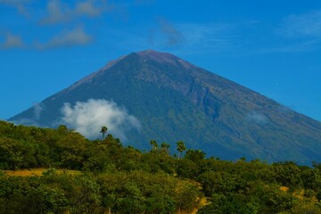 East coast of Bali - imposing active volcano Gunung Agung (3031 m, the highest point on Bali) dominates the surrounding area (Kecamatan Abang Subdistrict, Karangasem Regency, Bali, Indonesia)