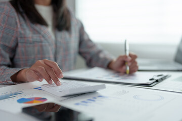 Confident Asian businesswoman working on laptop in modern office Accountants take care of finances, experts analyze business reports. Budget calculations on business growth files.